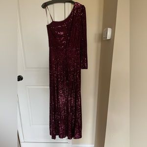 Xscape one shoulder long sleeve formal dress in the color “Wine”